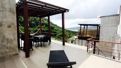 a patio with a table and chairs on a balcony at Villa Patong 3 Chambres in Patong Beach