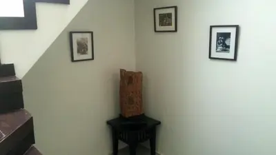a stair room with a chair and pictures on the wall at Villa Patong 3 Chambres in Patong Beach