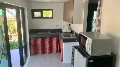 a small kitchen with a sink and a microwave at Villa Loma 4 Chambres in Patong Beach
