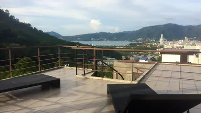 a balcony with two benches and a view of a city at Villa Loma 3 Chambres in Patong Beach