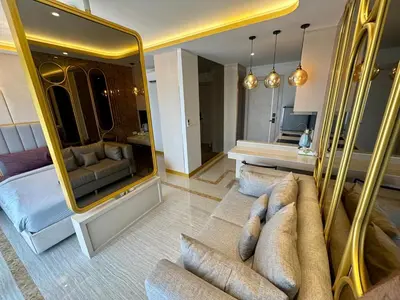 a living room with a couch and a large mirror at Bellevue Lagoon Phuket in Laguna Phuket
