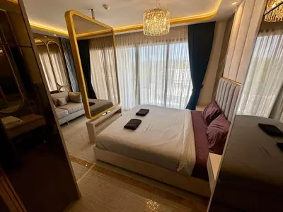 a bedroom with a large bed and a mirror at Bellevue Lagoon Phuket in Laguna Phuket