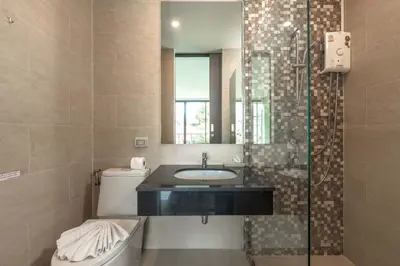a bathroom with a sink and a toilet and a shower at Vibrant Life at 4BR Pool Villa, Kata - UTK3 in Kata Beach