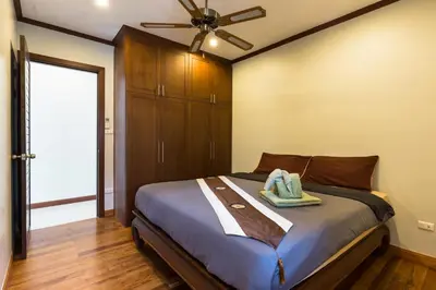 a bedroom with a bed with a ceiling fan at Thai-Balinese Villa Alex in Rawai, 3BR, Private Pool in Rawai Beach