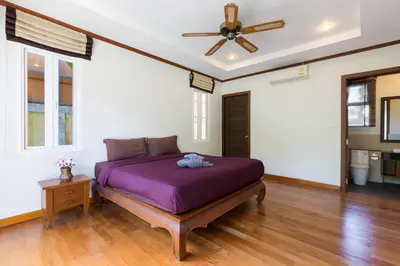 a bedroom with a purple bed and a ceiling fan at Thai-Balinese Villa Alex in Rawai, 3BR, Private Pool in Rawai Beach