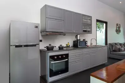 a kitchen with a refrigerator and a stove top oven at Thai Balinese Villa Rico in Kamala 3BR, Private Pool in Kamala Beach