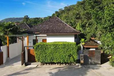 a house with a hedge in front of it at Thai Balinese Villa Rico in Kamala 3BR, Private Pool in Kamala Beach