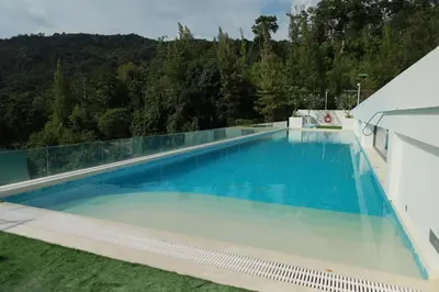 a large swimming pool with a mountain in the background at Fantasea Kamala 1 BR Apartments Near Beach 212 in Kamala Beach