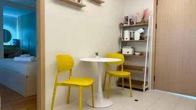 a table and chairs in a room with a bedroom at Fantasea Kamala 1 BR Apartments Near Beach 212 in Kamala Beach