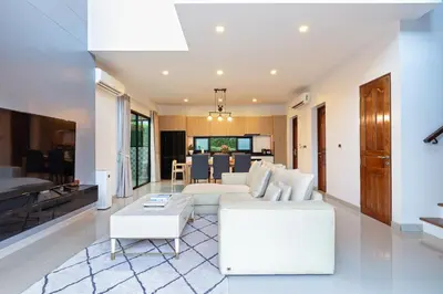 a living room with a white couch and a table at Phuket Nai Han Beach Villa with Pool in Rawai Beach