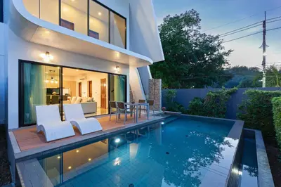 a villa with a swimming pool and a house at Phuket Nai Han Beach Villa with Pool in Rawai Beach