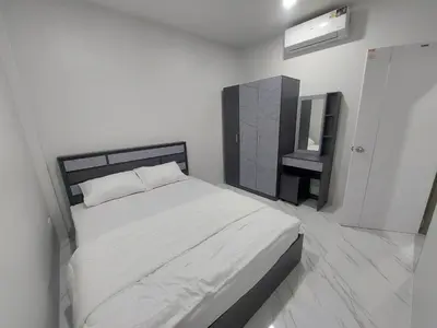 a white bedroom with a bed and a television at 629 Home for rent, Rawai in Ban Saiyuan (1)