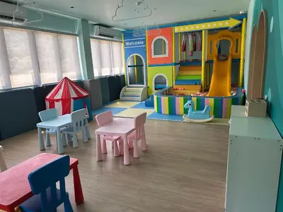 a childrens play room with a table and chairs at Wyndham studio 2205 in Surin Beach