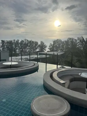 a swimming pool with three jacuzzis on top of a building at Wyndham studio 2205 in Surin Beach