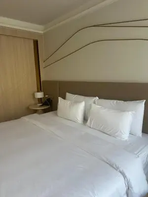 a large white bed with white pillows on it at Wyndham studio 2205 in Surin Beach