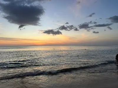 a sunset on the beach with the ocean at Wyndham studio 2205 in Surin Beach