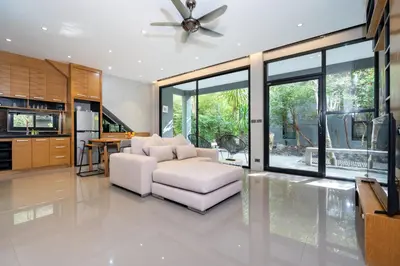 a living room with a white couch and a ceiling fan at Nature & Serenity - Exclusive Villa-Pavilion P06 in Natural Park Residence near Kamala Beac in Kamala Beach