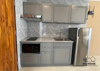 a kitchen with a sink and a refrigerator at 202 HOUSE near Bangtao Muay Thai & MMA in Ban Thalat Choeng Thale