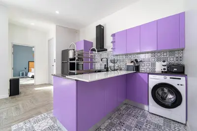 a purple kitchen with a washing machine in it at Brand New Design 2BR Villa Indra with Oxygen Pool in Rawai Beach