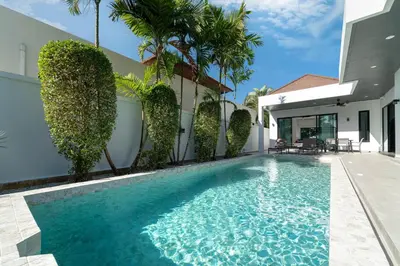 a swimming pool in front of a house at Brand New Design 2BR Villa Indra with Oxygen Pool in Rawai Beach