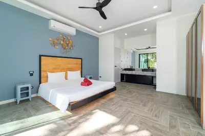 a bedroom with a large bed and a bathroom at Brand New Design 2BR Villa Indra with Oxygen Pool in Rawai Beach