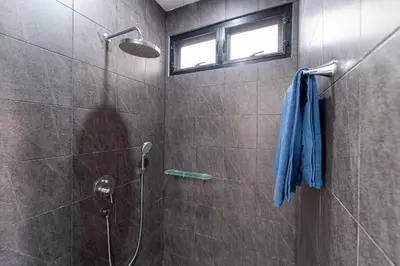 a bathroom with a shower with a blue towel at Brand New Design 2BR Villa Indra with Oxygen Pool in Rawai Beach