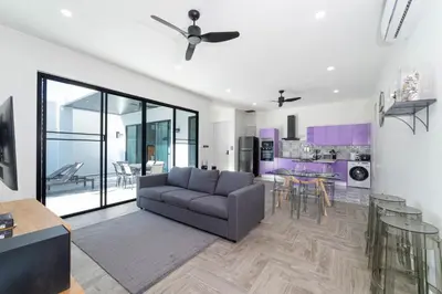 a living room with a couch and a kitchen at Brand New Design 2BR Villa Indra with Oxygen Pool in Rawai Beach