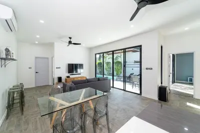 a living room with a glass table and a couch at Brand New Design 2BR Villa Indra with Oxygen Pool in Rawai Beach