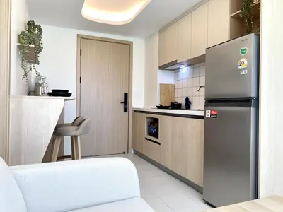 a kitchen with a stainless steel refrigerator and a counter at Fantasea Condo - Kamala in Kamala Beach