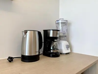 two coffee makers sitting on a counter next to a blender at Fantasea Condo - Kamala in Kamala Beach