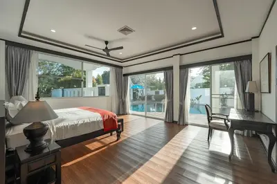 a bedroom with a bed and a desk and windows at V175 Huge 21M Pool 5-BR 1Km 2 Kamala Beach in Kamala Beach
