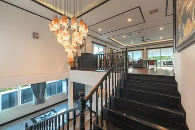 a staircase in a house with a chandelier at V175 Huge 21M Pool 5-BR 1Km 2 Kamala Beach in Kamala Beach