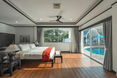 a bedroom with a bed and a swimming pool at V175 Huge 21M Pool 5-BR 1Km 2 Kamala Beach in Kamala Beach