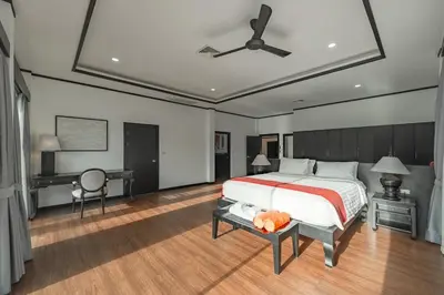 a bedroom with a bed and a desk and a ceiling fan at V175 Huge 21M Pool 5-BR 1Km 2 Kamala Beach in Kamala Beach