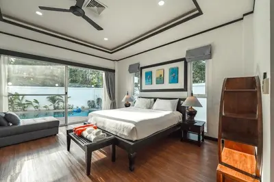 a bedroom with a bed and a couch at V175 Huge 21M Pool 5-BR 1Km 2 Kamala Beach in Kamala Beach