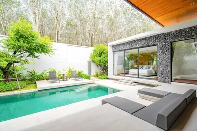 a swimming pool in the backyard of a house at 3BR Pool Villa at Botanica Modern Loft in Bangtao in Bang Tao Beach