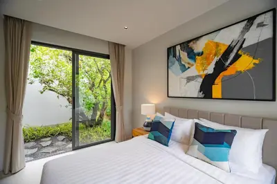 a bedroom with a bed and a large window at 3BR Pool Villa at Botanica Modern Loft in Bangtao in Bang Tao Beach