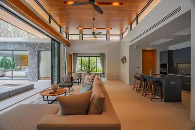 a living room with a couch and a table at 3BR Pool Villa at Botanica Modern Loft in Bangtao in Bang Tao Beach