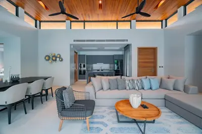 a living room with a couch and a table at 3BR Pool Villa at Botanica Modern Loft in Bangtao in Bang Tao Beach
