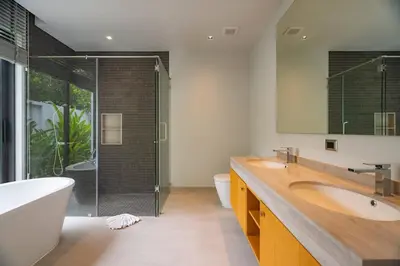 a bathroom with two sinks and a shower at 3BR Pool Villa at Botanica Modern Loft in Bangtao in Bang Tao Beach