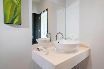 a bathroom with two sinks and a large mirror at Balinese Style 3BR Villa Morning Forest, Nai Harn in Rawai Beach