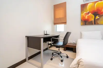 a bedroom with a desk and a bed and a desk chair at Balinese Style 3BR Villa Morning Forest, Nai Harn in Rawai Beach