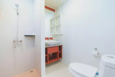 a bathroom with a white toilet and a sink at Apartments Near Bangtao Muay Thai & MMA in Ban Thalat Choeng Thale