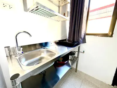 a bathroom with a sink and a window at Patong Canal Villa 107 in Patong Beach