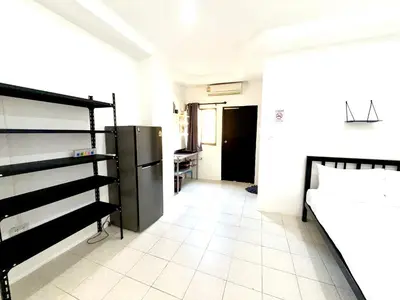 a room with a bed and a refrigerator in it at Patong Canal Villa 107 in Patong Beach