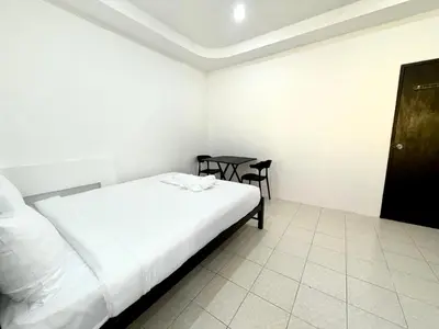 a small bedroom with a bed and a table at Patong Canal Villa 107 in Patong Beach
