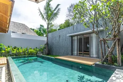 a swimming pool in front of a house at Anchan Flora by Villacarte in Ban Phru Champa