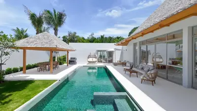 a swimming pool in the backyard of a villa at Anchan Flora by Villacarte in Ban Phru Champa