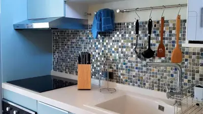 a kitchen with a sink with utensils on the wall at 01 - Beach Villa Retreat in Nai Yang Beach