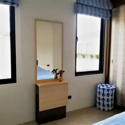 a bedroom with a mirror and a dresser and a bed at 01 - Beach Villa Retreat in Nai Yang Beach